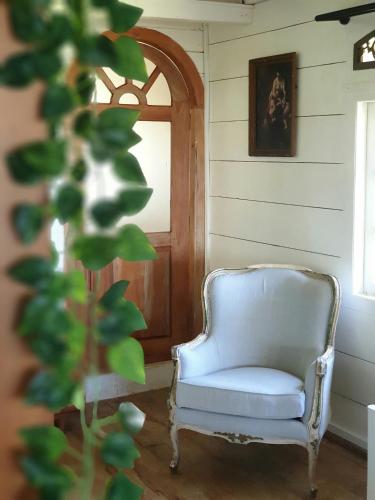 a white chair in a room with a door at Memo's Beach in Nilaveli