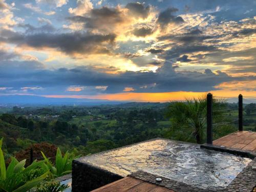 a view of a sunset from a roof of a house at Bio Habitat Hotel in Armenia