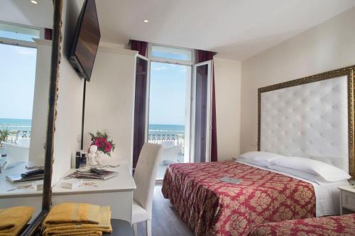 Postel nebo postele na pokoji v ubytování Hotel Lido