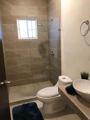 a bathroom with a shower and a toilet and a sink at Beautiful 3 BR/3.5 bath Home@Selvanova in Playa del Carmen