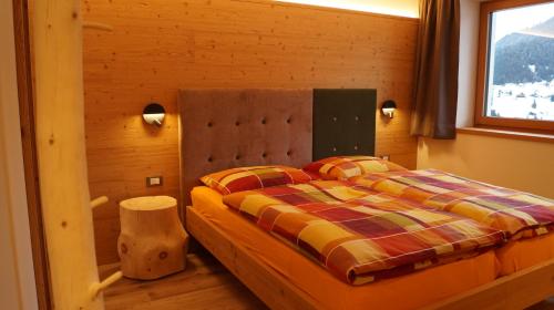 a bedroom with a bed and a window at Apartments Salieta in Santa Cristina in Val Gardena