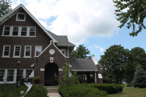a red brick house with a gambrel roof at Iowa House Historic Inn in Ames