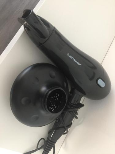 a black hair dryer sitting on a table at L’atelier St Remacle in Liège