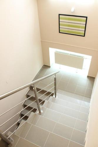 a staircase in a house with a window at Alice Vendégház in Kalocsa