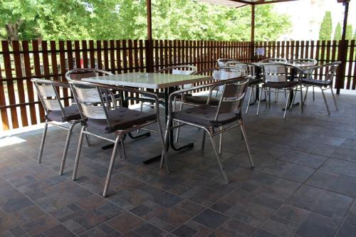 a group of tables and chairs on a patio at Alice Vendégház in Kalocsa