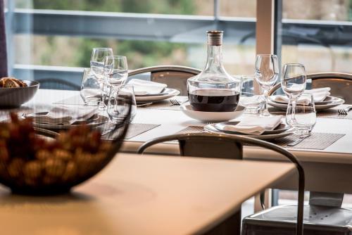 a table with wine glasses and a bowl of food at Résidences Alticimes in Brides-les-Bains