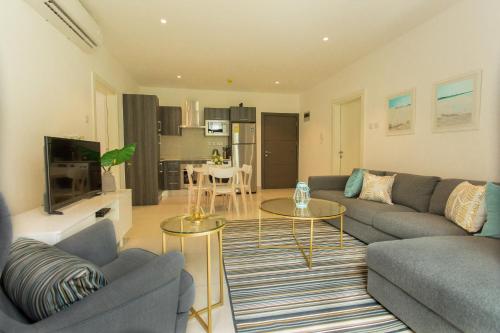 a living room with a couch and a table at Accra Luxury Apartments @ The Gardens in Accra