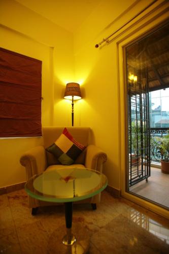 a living room with a couch and a glass table at juSTa Off MG Road in Bengaluru