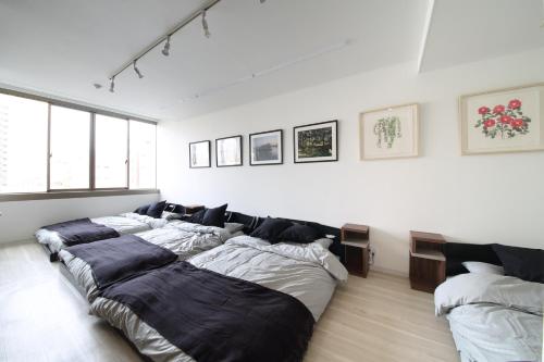 a group of four beds in a room at Culinary Bed&Art 401 in Hamamatsu