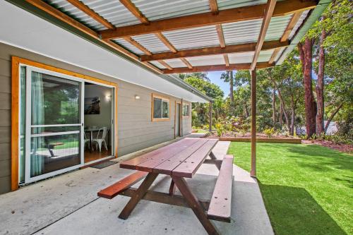 a picnic table on the patio of a house at NRMA South West Rocks Holiday Park in South West Rocks