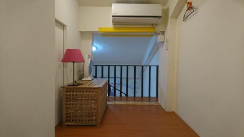 a hallway with a balcony with a heater and a lamp at Ho Hai Yan Homestay in Chenggong