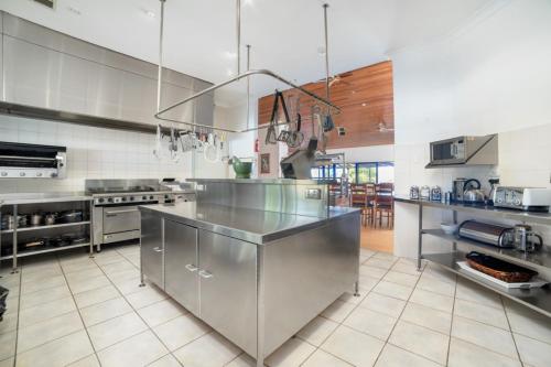 a large kitchen with a large stainless steel counter at Doyles on the Bay in Kingscote