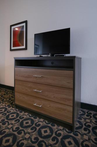 a dresser with a flat screen tv on top of it at Quality Inn & Suites Boone - University Area in Boone