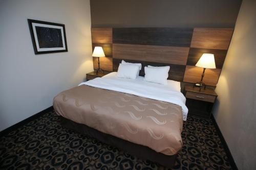 a hotel room with a large bed with two lamps at Quality Inn & Suites Boone - University Area in Boone