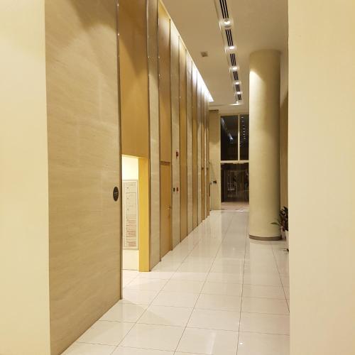a hallway of an office building with wooden walls at Afiniti Residensi Legoland Medini in Nusajaya