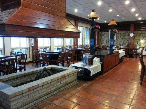 a restaurant with a large kitchen and tables and chairs at Huis Ten Bosch in Renai