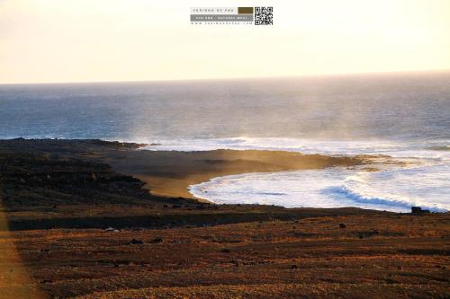 an aerial view of a beach with the ocean at FARINHA DE PAU - ECO B&B in Tarrafal