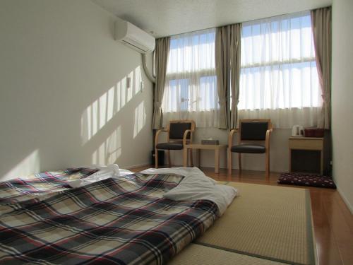 Postel nebo postele na pokoji v ubytování Fujibou Hotel