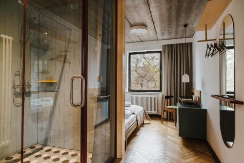 a bathroom with a shower and a bedroom at Willa Wincent in Gdynia