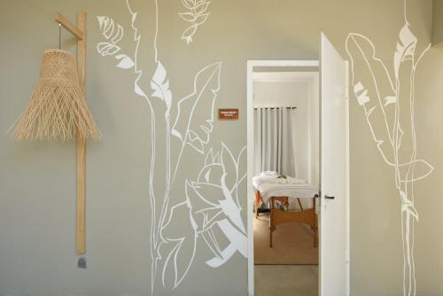 a hallway with a wall mural of flowers at Veranda Tamarin Hotel & Spa in Tamarin