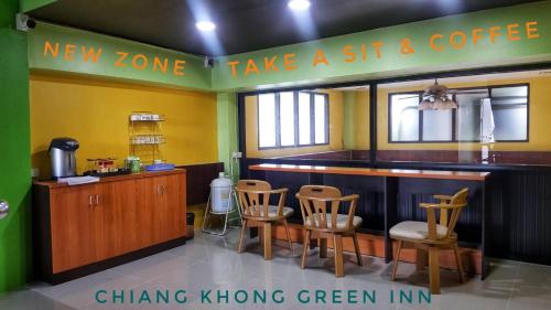 a restaurant with a bar with chairs and a sign saying take a sip and coffee at Chiangkhong Green Inn Resident in Chiang Khong