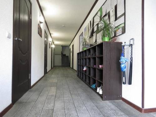 a corridor of a hallway with a door and a shelf with shoes at Хостел-Биг Хостел, Большой Хостел in Kaliningrad