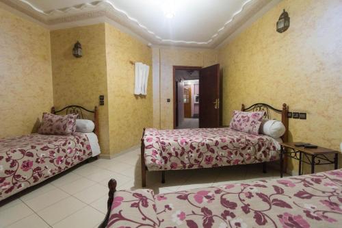 a hotel room with two beds in a room at Hotel Bab Boujloud in Fès