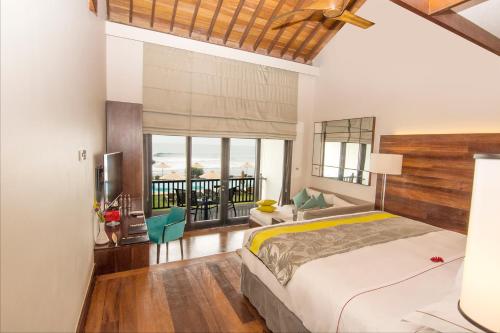 a bedroom with a bed and a view of the ocean at The Fortress Resort & Spa in Koggala