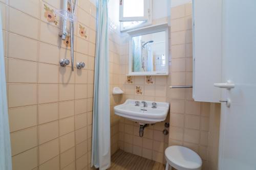 a bathroom with a sink and a toilet at Hotel Maris Stella in Riccione