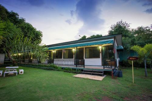 a small house with a porch and a yard at Goldengold (Khaoyai) Resort & Spa in Mu Si