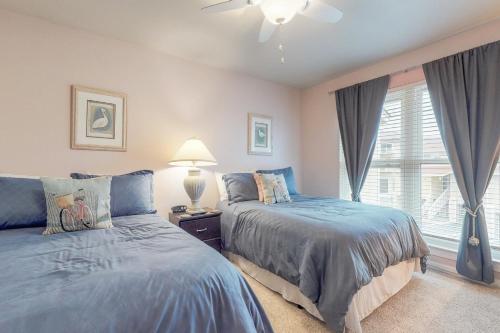 a bedroom with two beds and a window at Regency Cabanas #D4 in Pensacola Beach