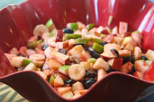 a red bowl of food with fruits and vegetables at Hamra Urban Gardens in Beirut