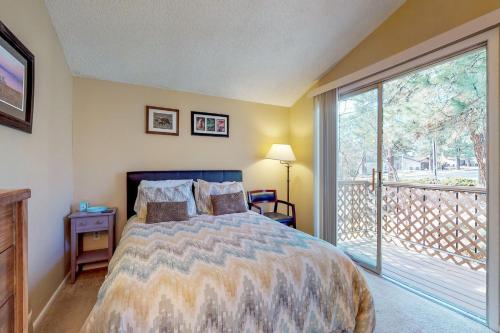 a bedroom with a bed and a large window at Village at Mt. Elden in Flagstaff
