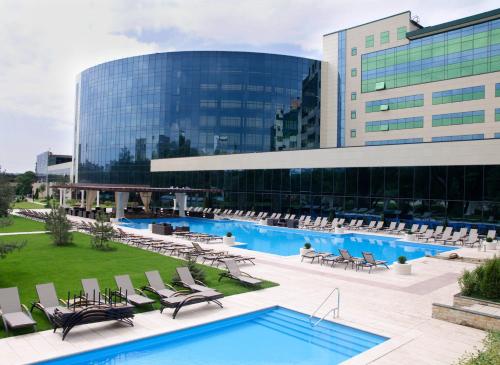 a large building with a pool in front of a building at Hotel Misto SPA & FITNESS in Kharkiv