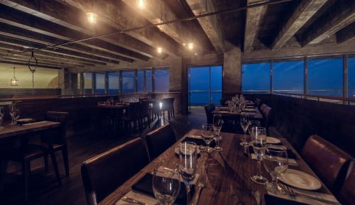 a restaurant with tables and chairs with wine glasses at Pledge Scape in Negombo
