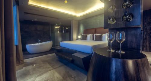 a bedroom with a bed and a bath tub and a bed and a bath tub at Pledge Scape in Negombo