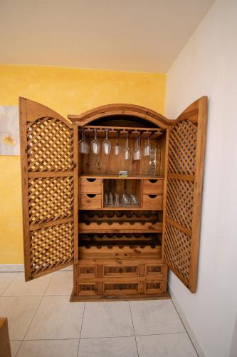 a wine cellar with wooden cabinets and wine glasses at Villa Salza in Sankt Martin am Grimming
