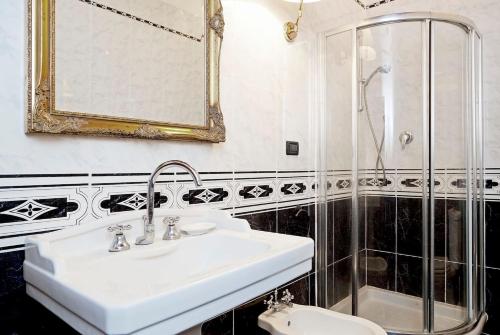 a bathroom with a sink and a shower at Villa Eugenia Tuscany with private Pool, Sauna & Gym in Vicchio