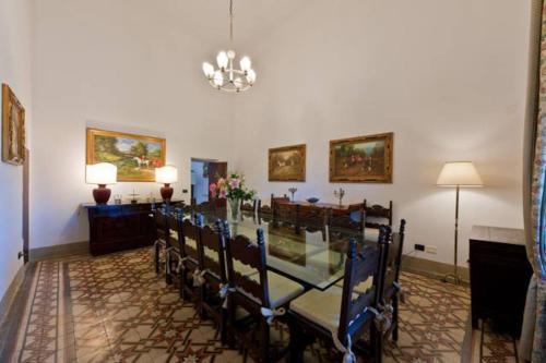 a dining room with a long table and chairs at Villa Eugenia Tuscany with private Pool, Sauna & Gym in Vicchio
