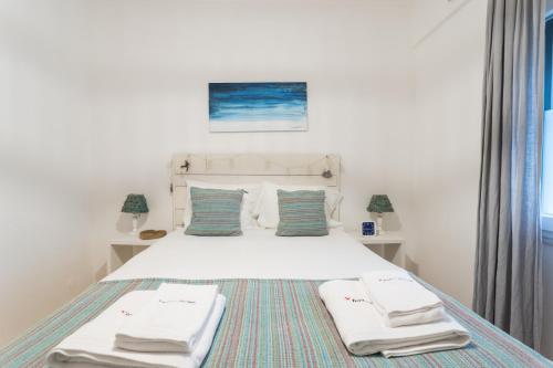 a bedroom with a white bed with towels on it at FLH Alfama Charming Flat in Lisbon