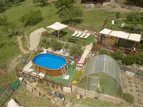 Agriturismo Terra e Cielo في Serra Rocco: اطلالة جوية على حديقة خلفية مع مسبح و منزل