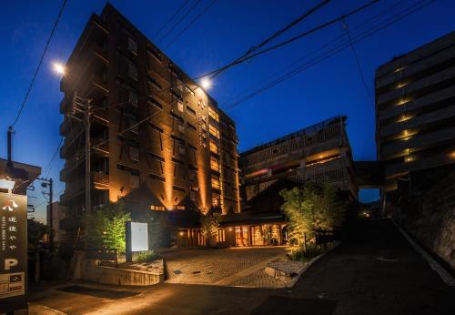 an apartment building at night with lights on at DogoYaya in Matsuyama