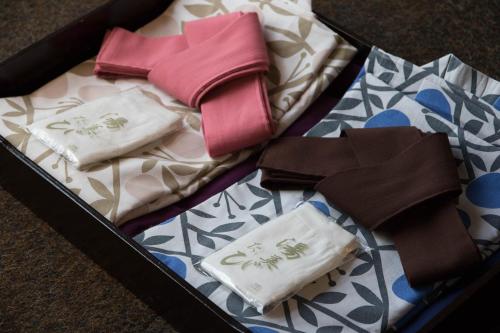 a box filled with clothes and ties on a table at DogoYaya in Matsuyama