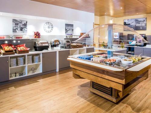 a kitchen with a counter with food on it at LA SUITE ENCHANTÉE Disneyland Paris in Serris