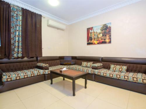 a waiting room with couches and a table at شاطئ البساتين للشقق المخدومة in Jeddah