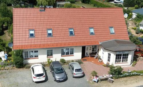 an aerial view of a house with cars parked in front at Pension Zur Sülte in Sülte