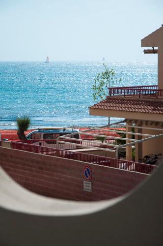 a view of the ocean with a boat in the water at Alma di Alghero Hotel in Alghero