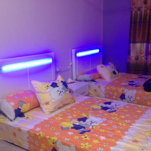two beds with hello kitty pillows in a bedroom at Sweet Home Flat 2 in Hurghada