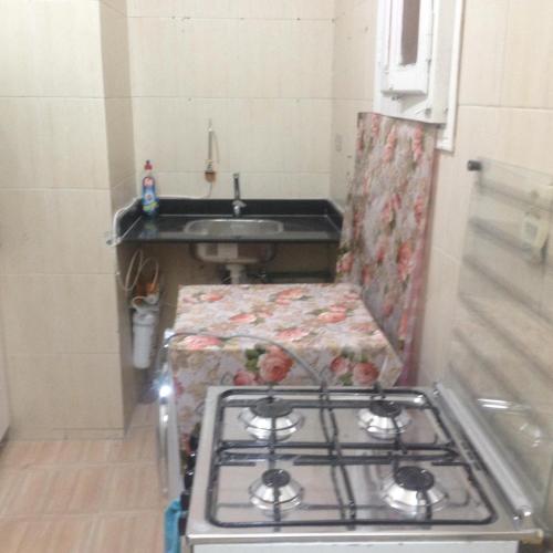 a stove in a small kitchen with a sink at Sweet Home Flat 2 in Hurghada
