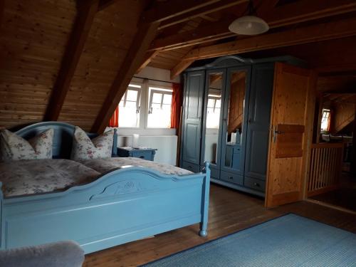 a bedroom with a white bed in a room with wooden ceilings at SPREEHOF Göbeln in Großdubrau
